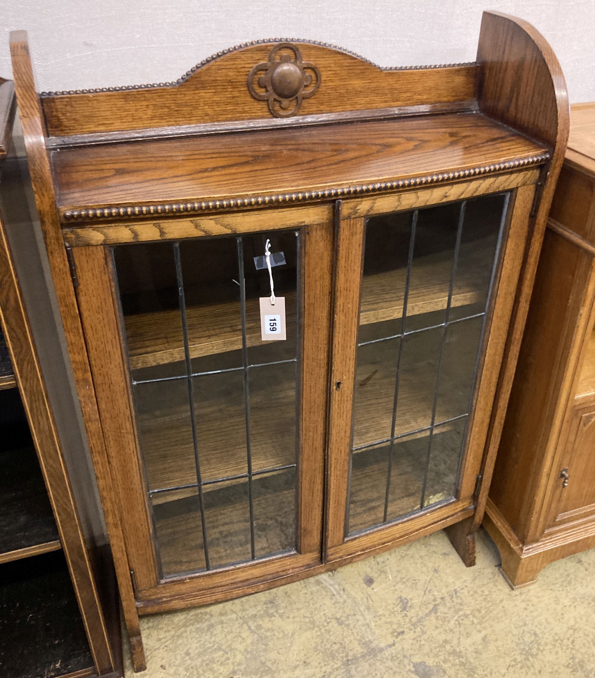 A 1920s oak bow front bookcase, length 73cm, width 26cm, height 110cm